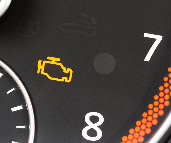 Up close of a check engine light illuminated on the dash
